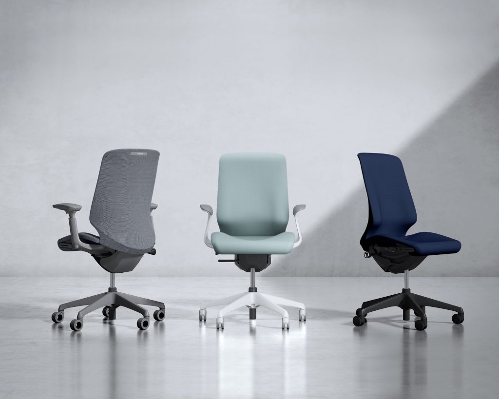 three chairs in gray, teal and blue in front of a grayscale background