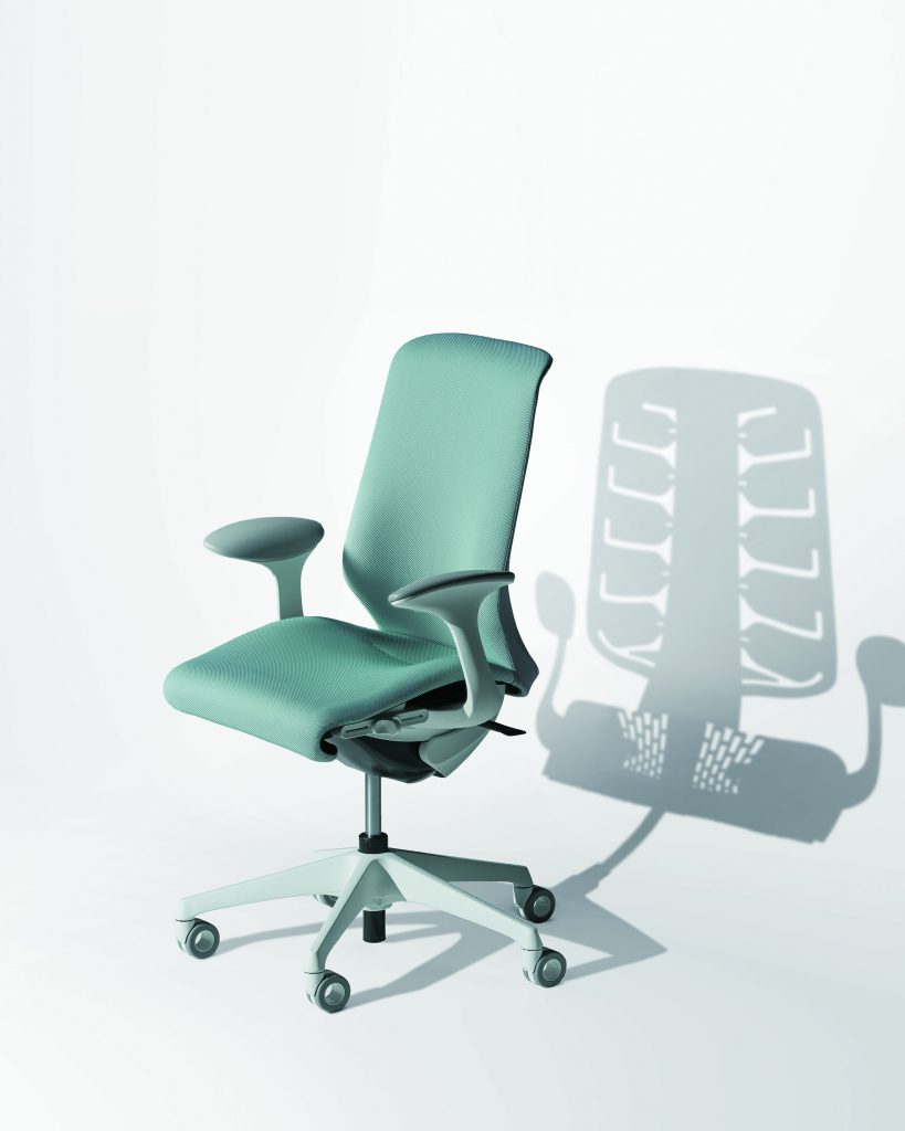 teal chair in front of a white background a light that transmits the chairs shadow